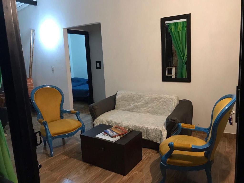 a living room with a couch and two chairs at Casa en la Montaña in Macanal