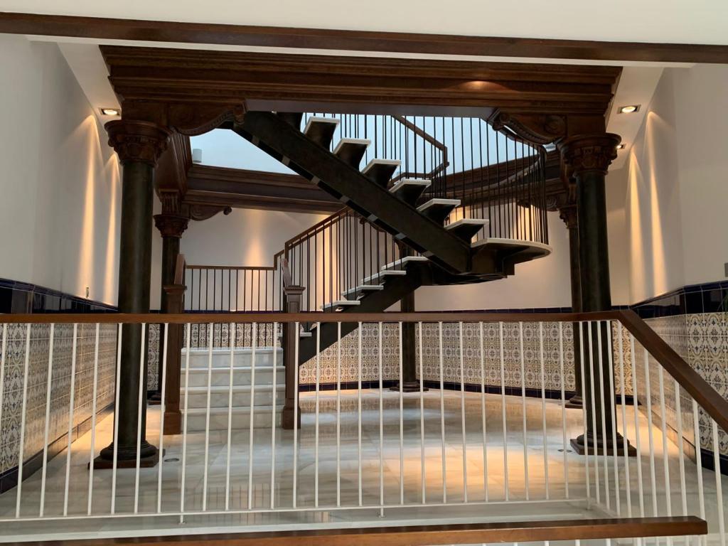 a staircase in a house with a wooden railing at TARASKA BARRIA. Céntrico y coqueto en zona tranquila in Bermeo