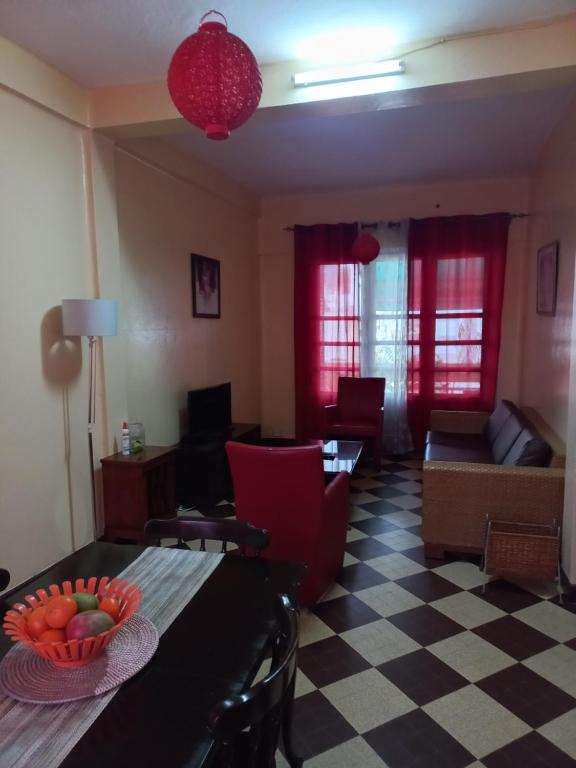 una sala de estar con una mesa con un bol de fruta. en Appartement sympathique Jules Ferry., en Dakar