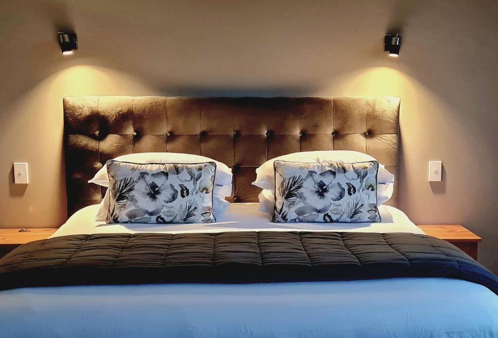 a bedroom with a large bed with two pillows at Okauia House, Matamata in Matamata