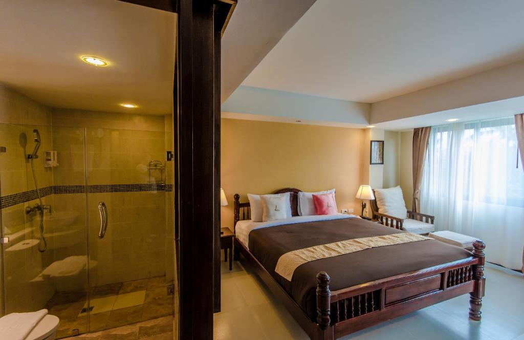 Postel nebo postele na pokoji v ubytování Goldenbell Hotel Chiangmai