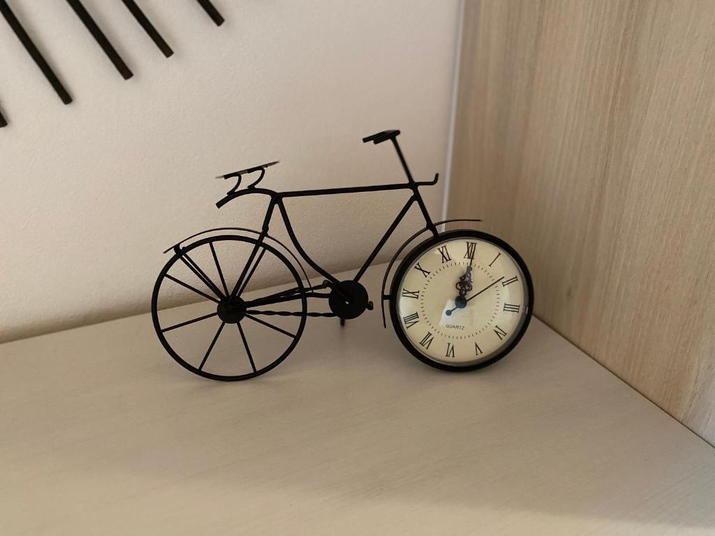 a clock is hanging on a wall next to a bike at Au-Doux-Altic chalet romantique avec JACUZZI ET SAUNA in Métabief