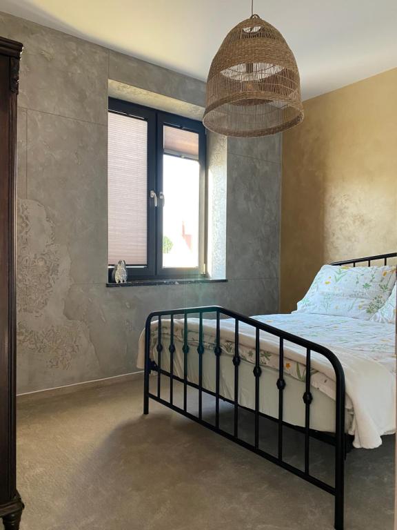 a bedroom with a bed and a window at Empero Apartments Bardejov 1 in Bardejov