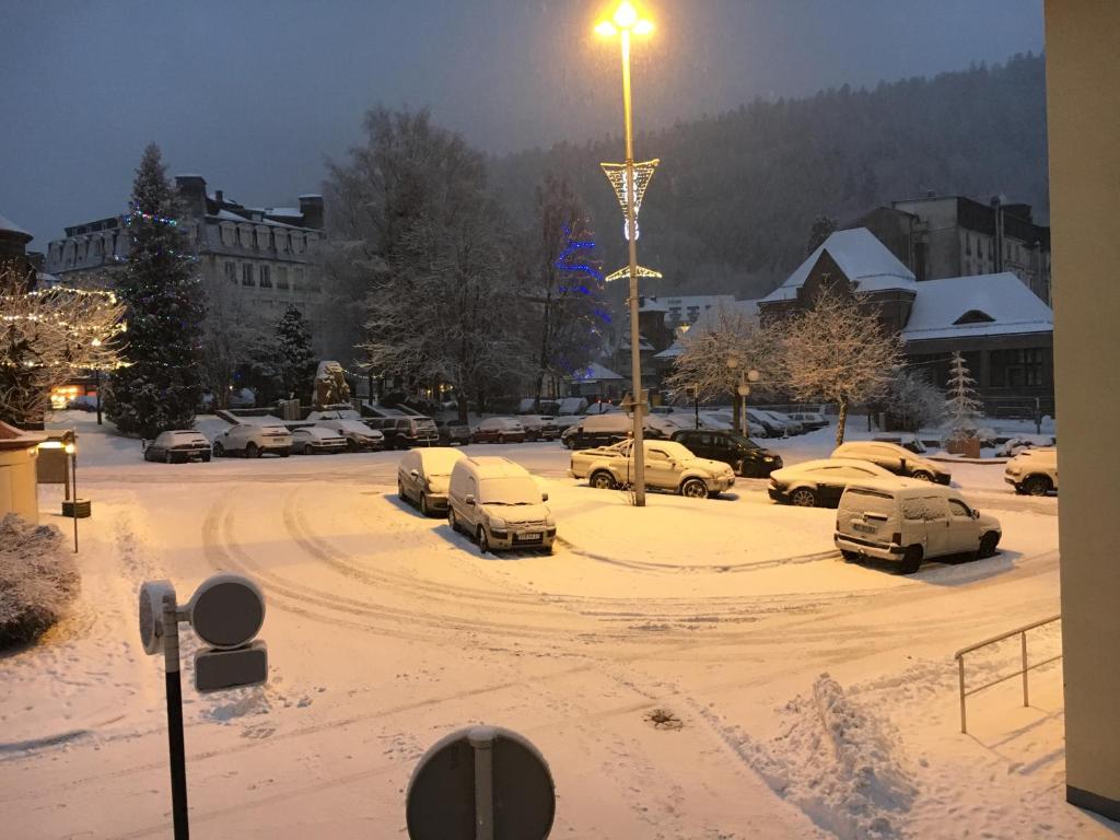 parking pokryty śniegiem z zaparkowanymi samochodami w obiekcie La Residence 2 w mieście Mont-Dore