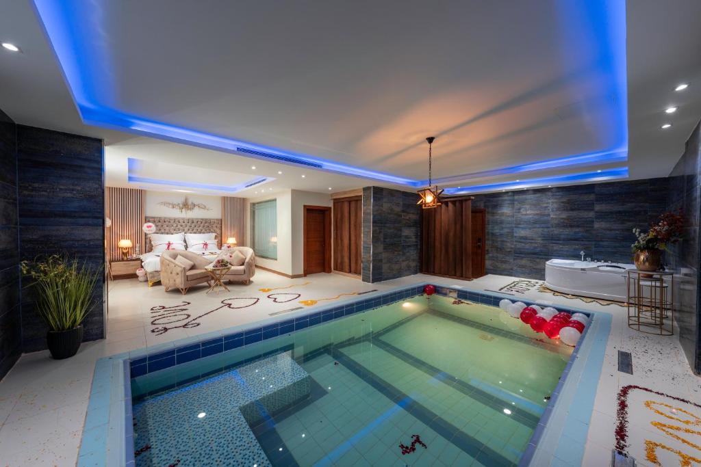 a large swimming pool in a living room at فندق الرؤية الجديدة in Jazan