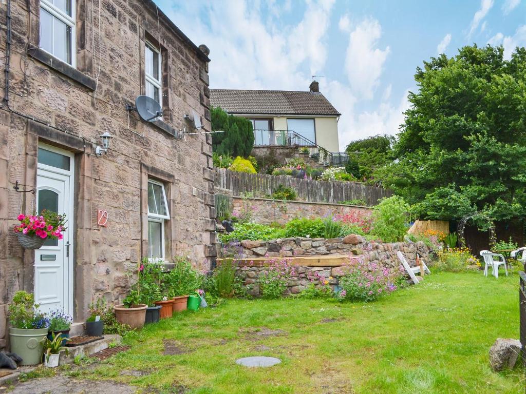 a stone house with a garden in front of it at Number 29 in Wooler