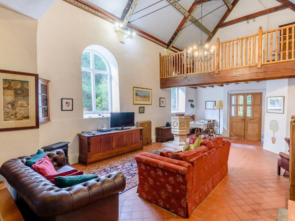 a living room with two couches and a tv at St Andrews Church in East Barkwith