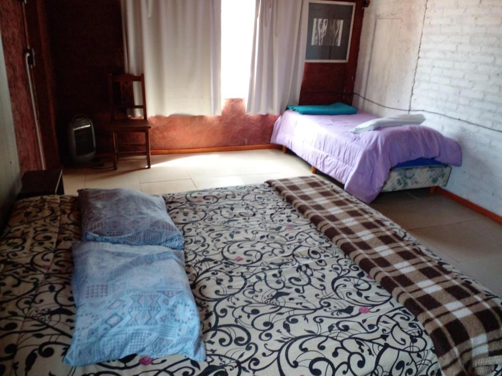 a bedroom with a bed and a large rug at Terra II in Villa Carlos Paz
