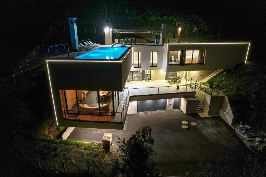 een huis met een zwembad in de nacht bij Villa Wineyard - VinoGrad in Banja Luka