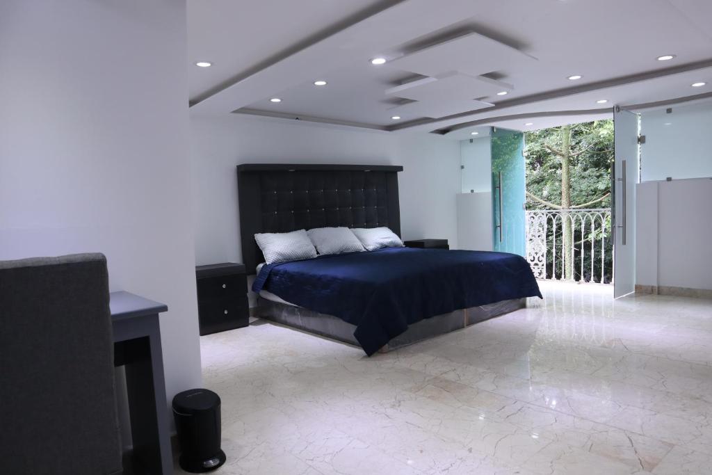 a bedroom with a bed and a tv in it at London 248 in Mexico City