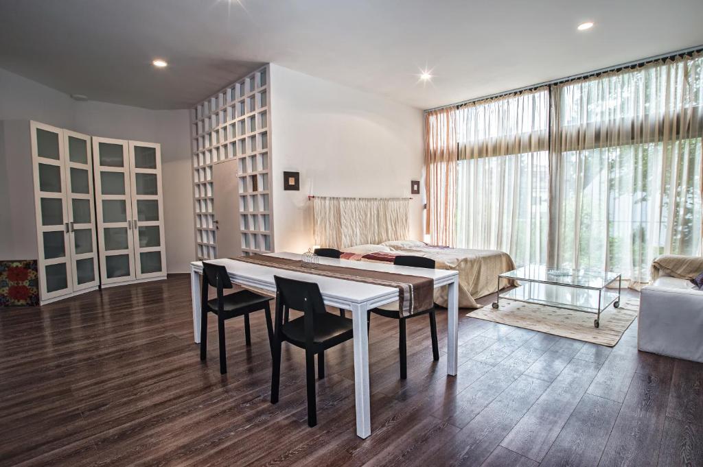 a living room with a table and chairs and a bed at Apartment Breeze in Bratislava