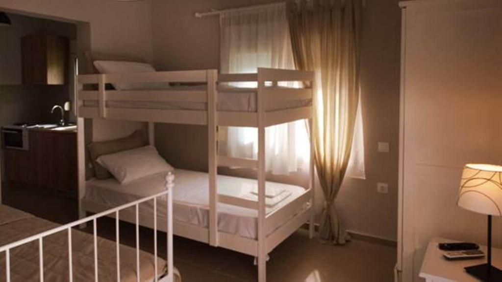 kilka łóżek piętrowych w pokoju w obiekcie Smaragdi Studios w mieście Pefkari