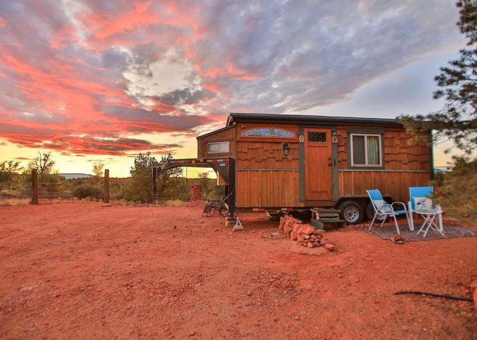 a tiny house sitting on top of a dirt field at The Gnome Home SEDONA'S MOST VISITED in Sedona