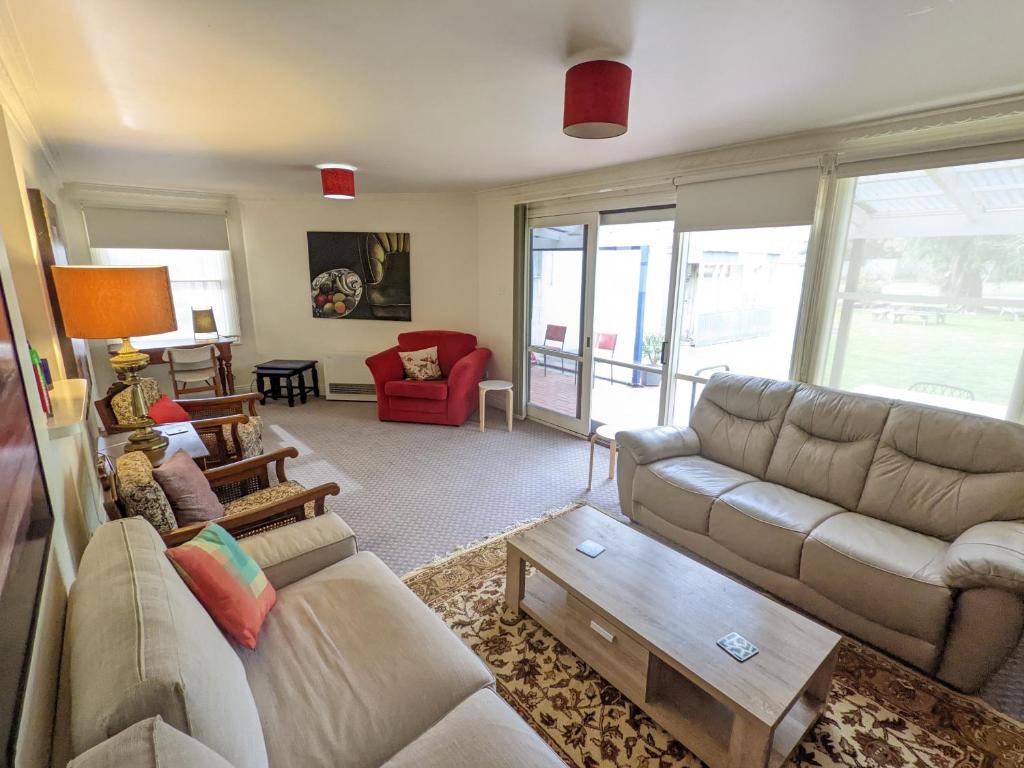 a living room with a couch and a table at The F Project Residence - whole house in Warrnambool