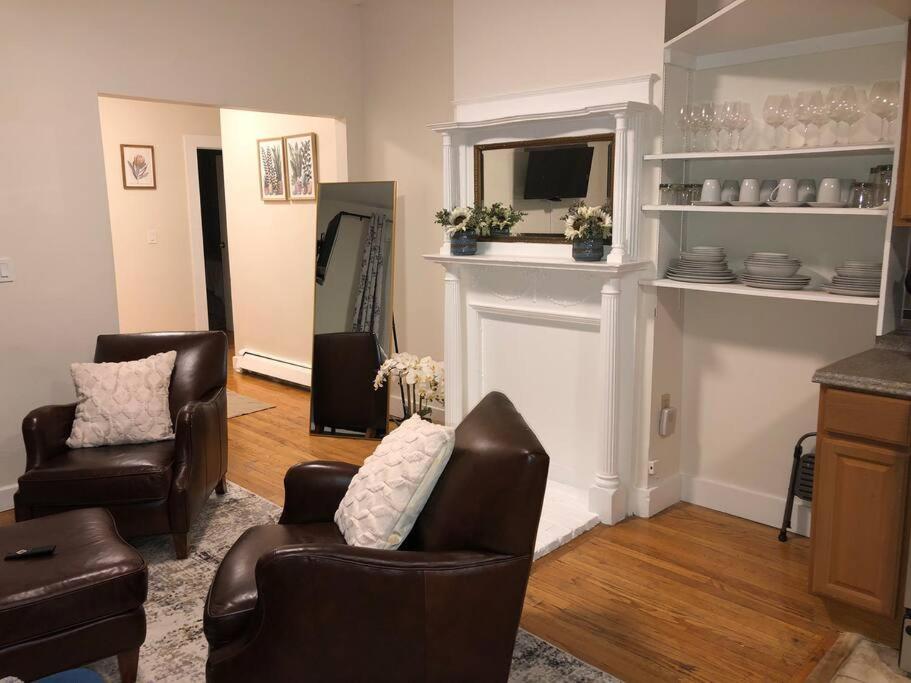 a living room with two chairs and a fireplace at Home away from Home! A place to focus and relax! in Cambridge