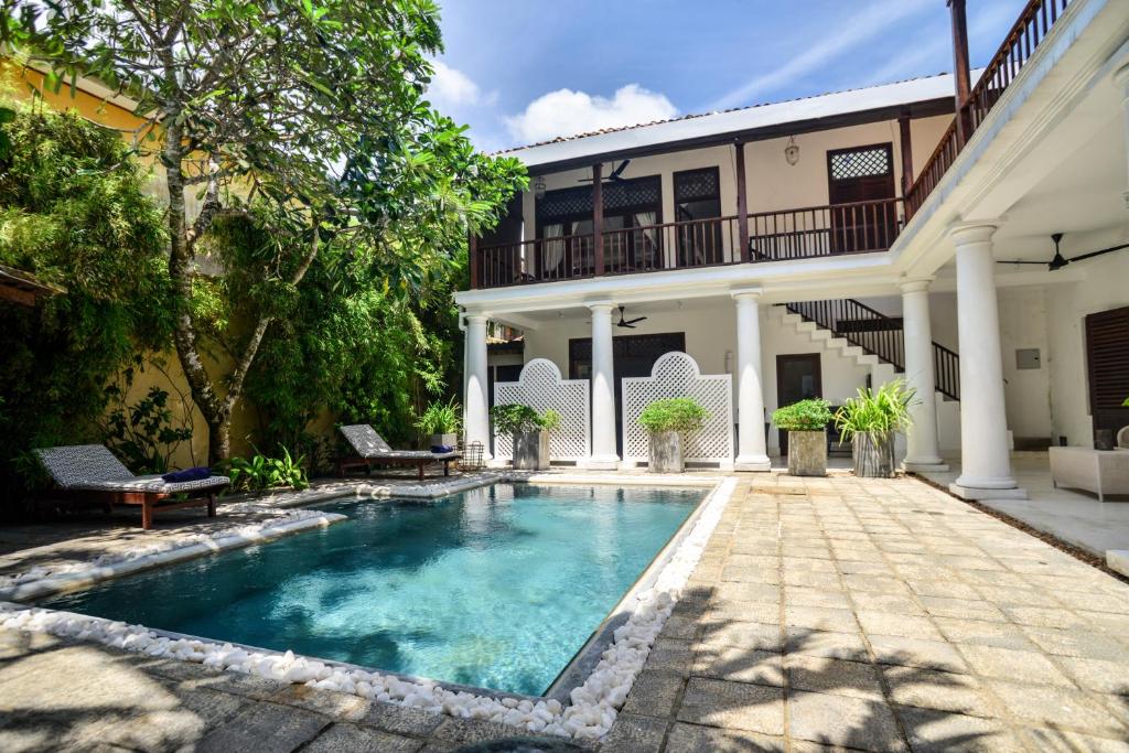 a swimming pool in front of a house at Villa 32 Middle Street in Galle