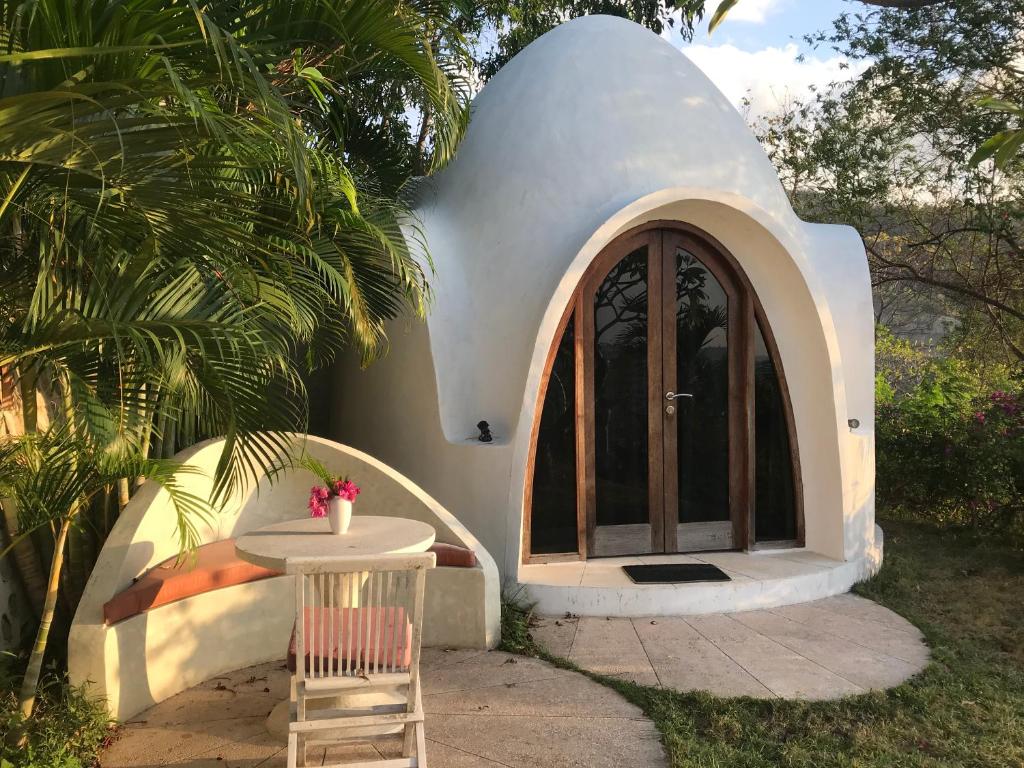 una pequeña casa con mesa y silla en Villa Hopedome, en Teluknarat