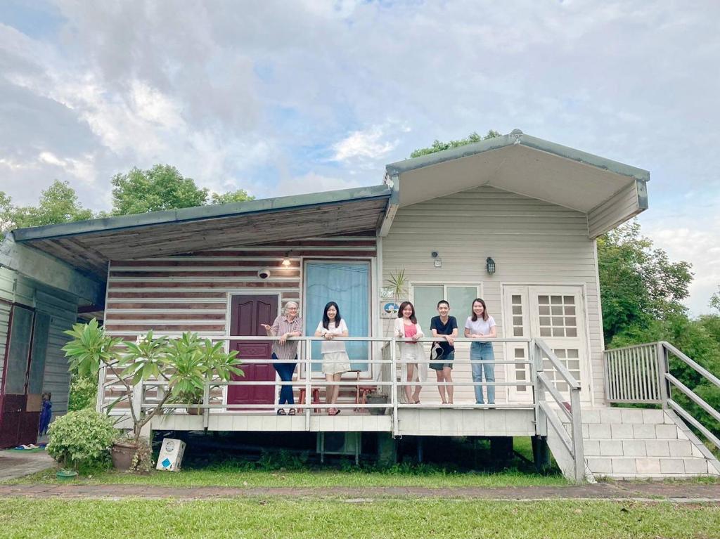 a group of women standing on the porch of a tiny house at Taroko Railway Authentic B&B in Xiulin