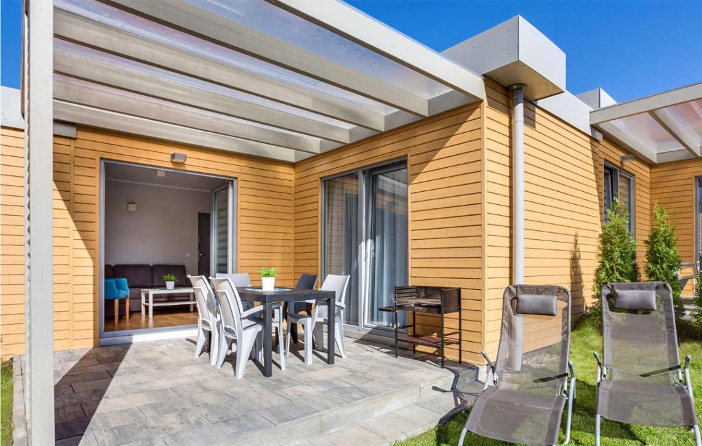 a patio with a table and chairs on it at Awesome Home In Rewal in Rewal