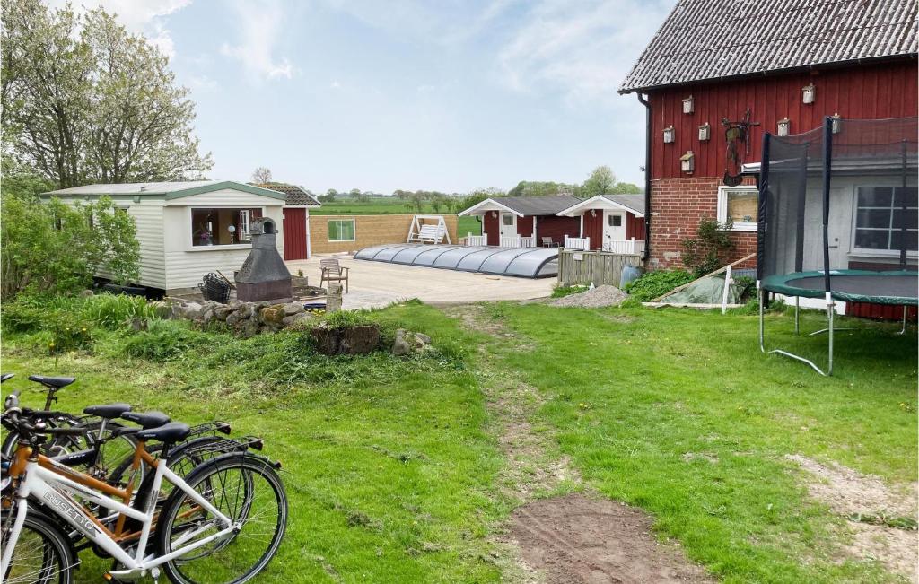 a group of bikes parked next to a red barn at Beautiful Apartment In Morup With Wifi in Morup