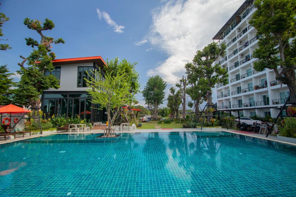 a large swimming pool in front of a building at UR The Private Huahin in Hua Hin