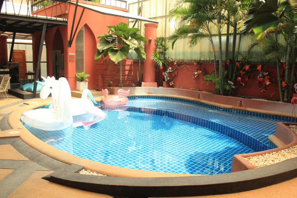 a swimming pool with a slide in a building at Kudos Boutique Hotel in Nong Prue