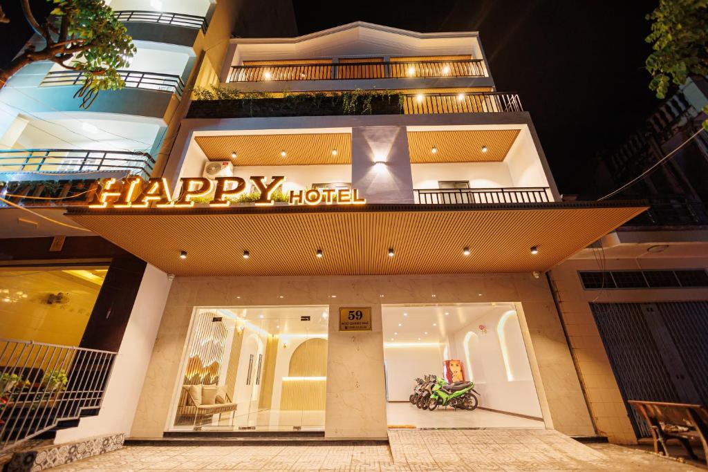 Bạc LiêuにあるHappy Hotelのホテルの前にホテルの看板が表示されています。