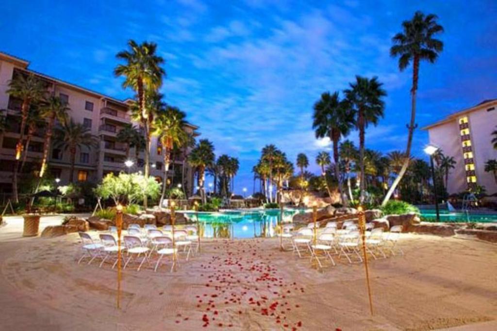 a beach with chairs and a swimming pool at a resort at Suites at Tahiti Village Resort and Spa-No Resort Fee in Las Vegas