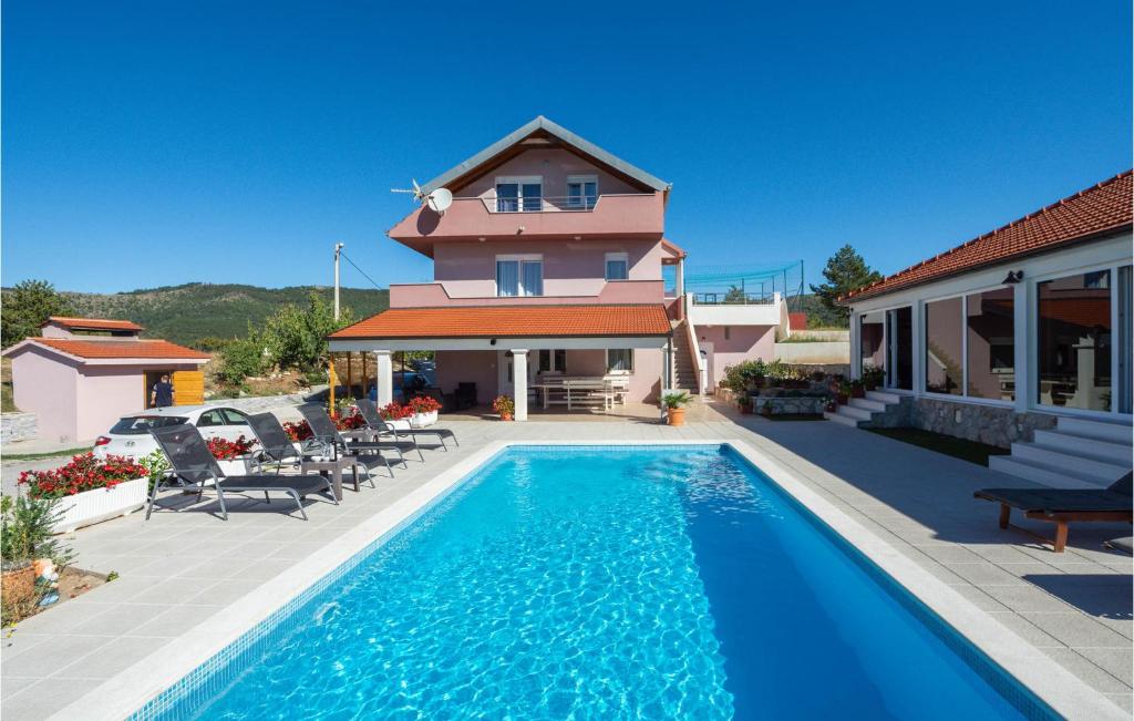 a house with a swimming pool in front of a house at Beautiful Home In Neoric With Private Swimming Pool, Can Be Inside Or Outside in Neorić