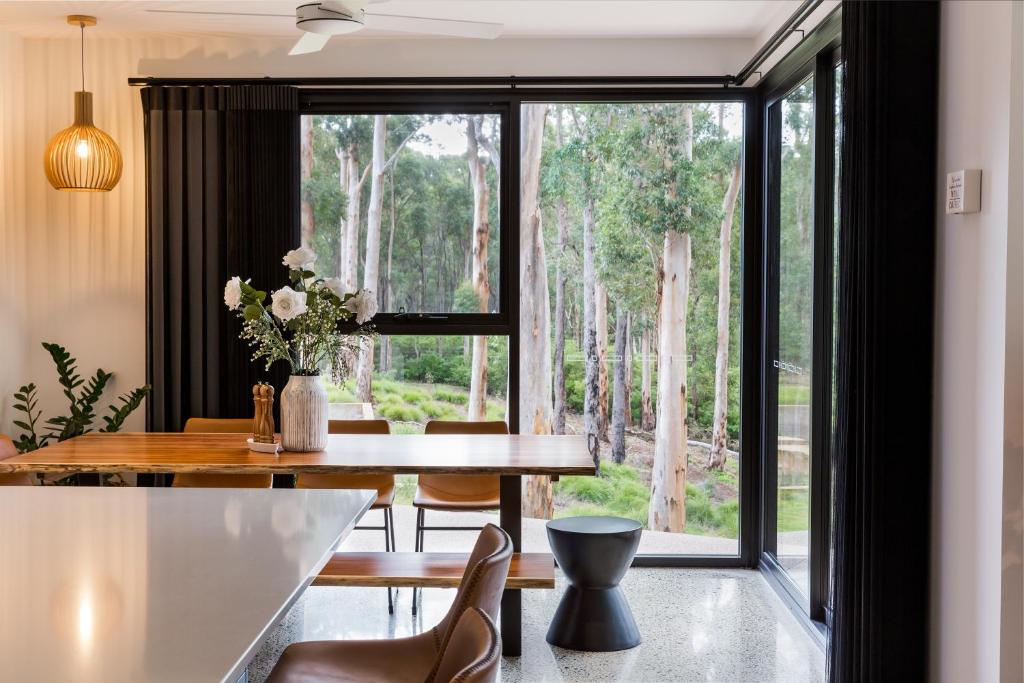 a dining room with a table and a large window at Kaya Karri in Margaret River Town