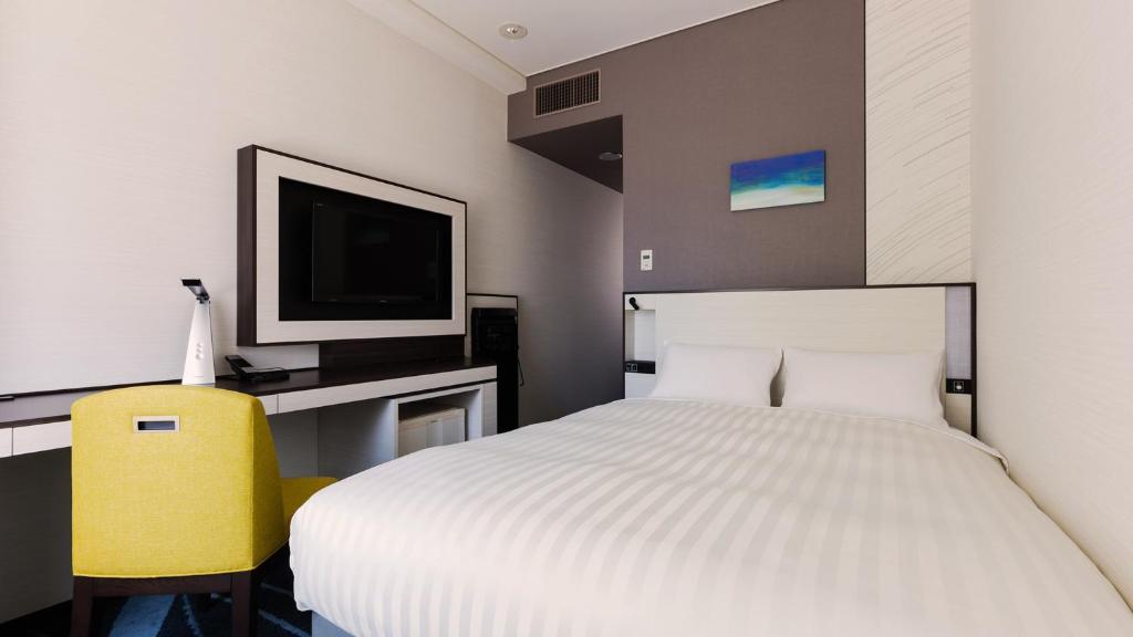 Postel nebo postele na pokoji v ubytování JR-East Hotel Mets Musashisakaii