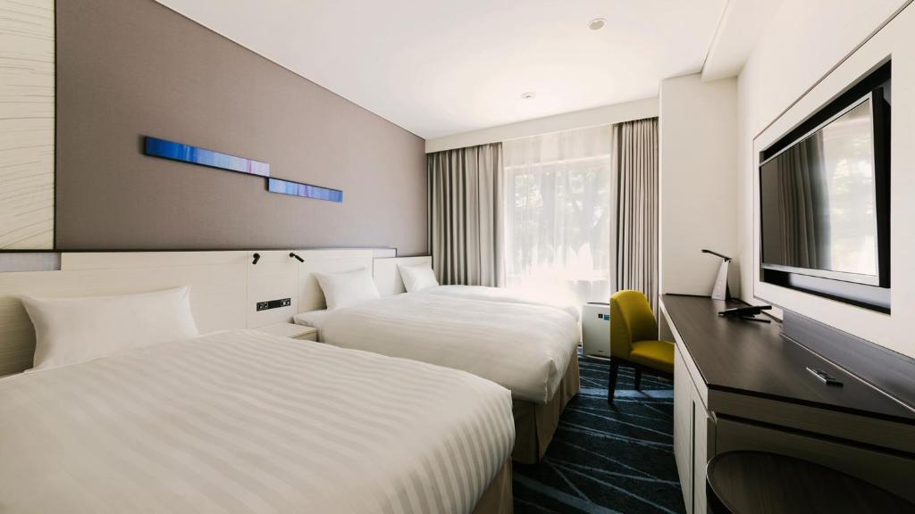 Postel nebo postele na pokoji v ubytování JR-East Hotel Mets Musashisakaii