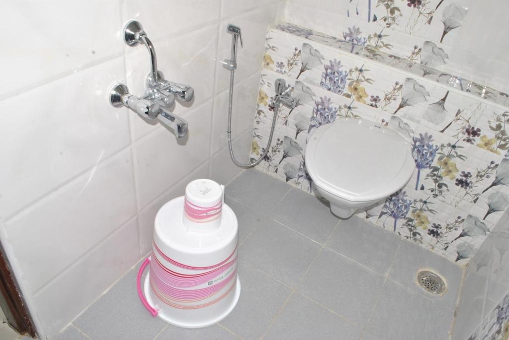 a bathroom with a toilet and a sink at HOTEL THE ROYAL PARK in Bangalore