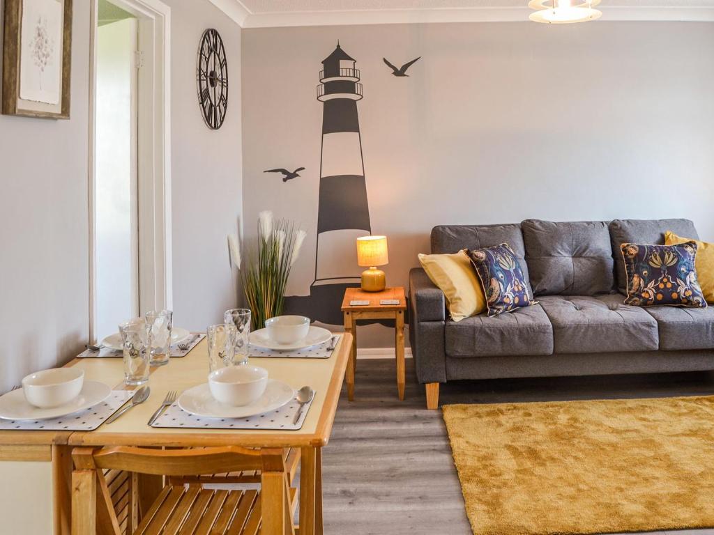a living room with a couch and a lighthouse on the wall at Meadow Crest in Belton