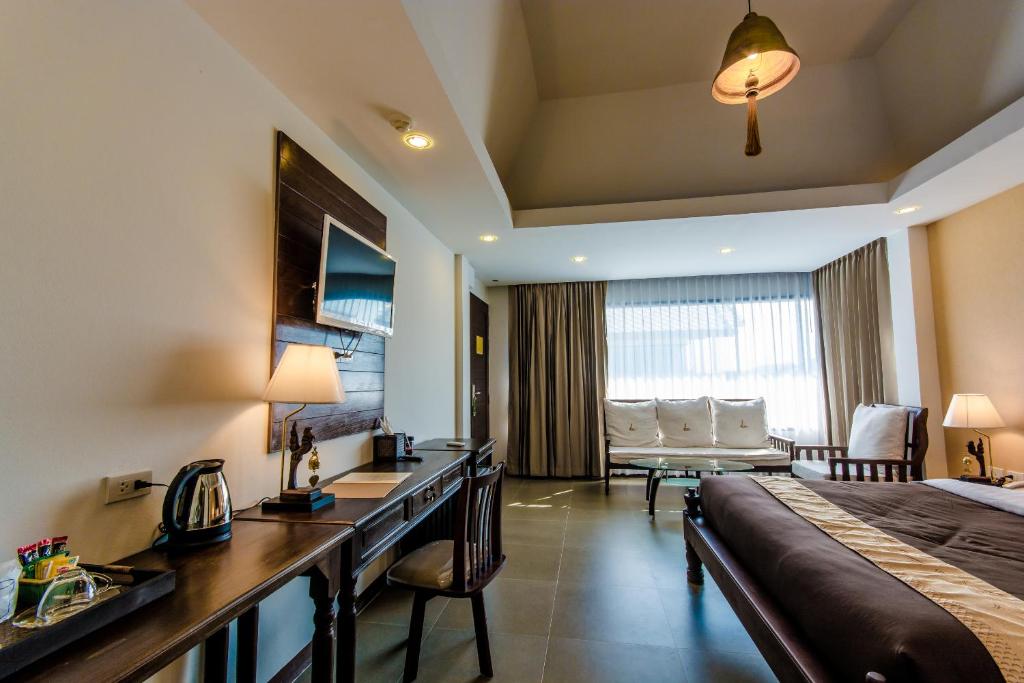 Postel nebo postele na pokoji v ubytování Goldenbell Hotel Chiangmai
