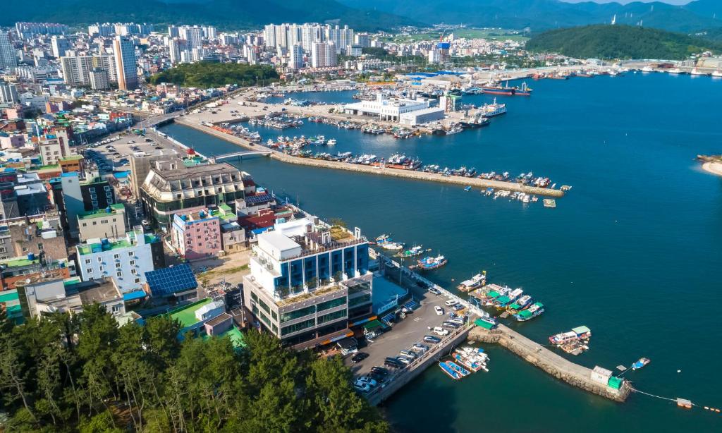 an aerial view of a city with a harbor at Owl Hotel in Sacheon
