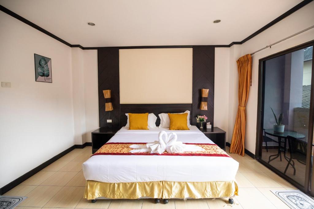 Postel nebo postele na pokoji v ubytování Lily Holiday hotel 百合假日酒店