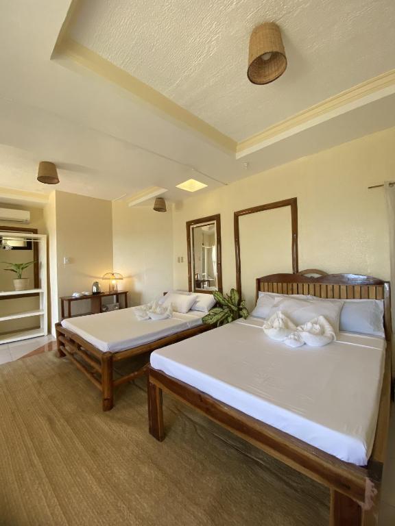 Postel nebo postele na pokoji v ubytování Tahanan Resort