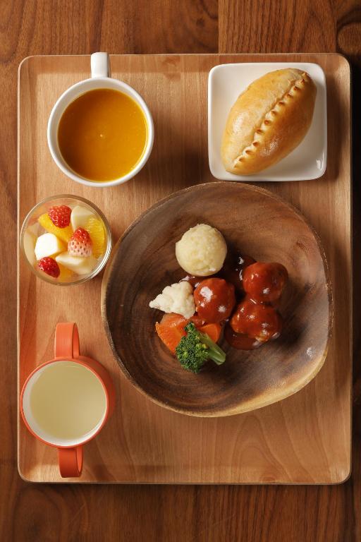 a wooden tray with a plate of food and a sandwich at Matsumoto Jujo in Matsumoto
