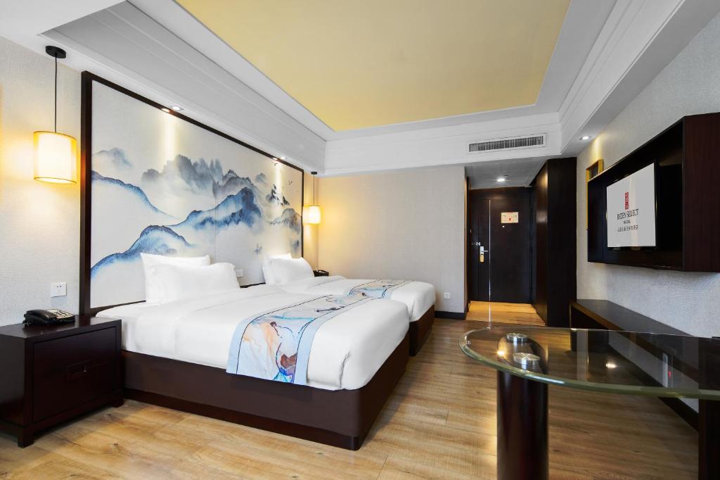 Postel nebo postele na pokoji v ubytování Foshan Rezen Select Pasonda Hotel
