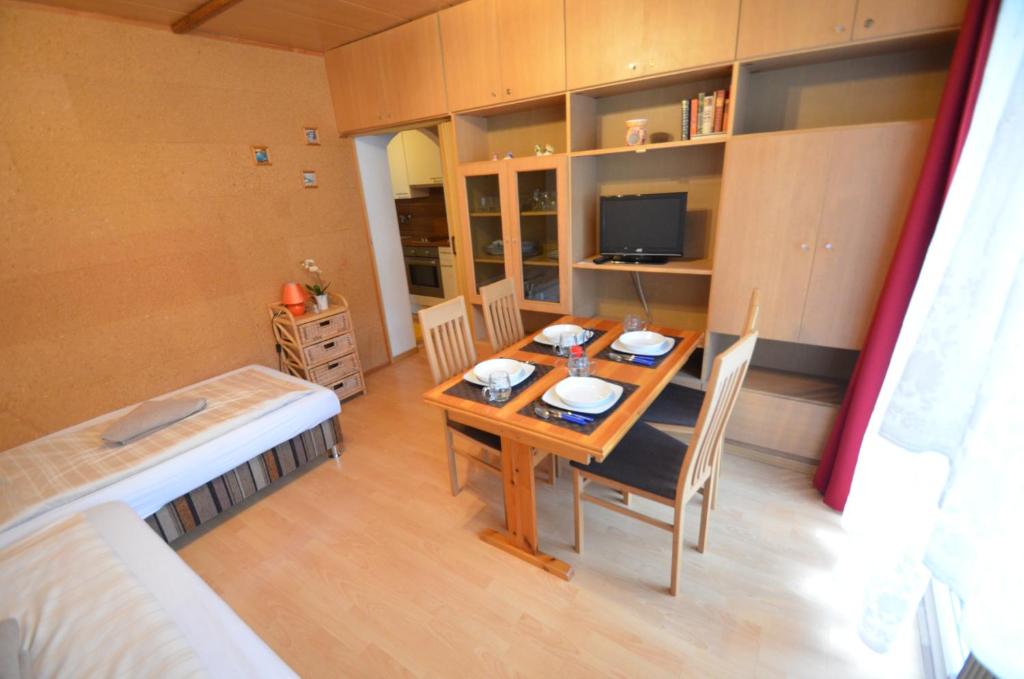 a room with a table and a bed and a bedroom at Apartment Alena in Saalbach Hinterglemm