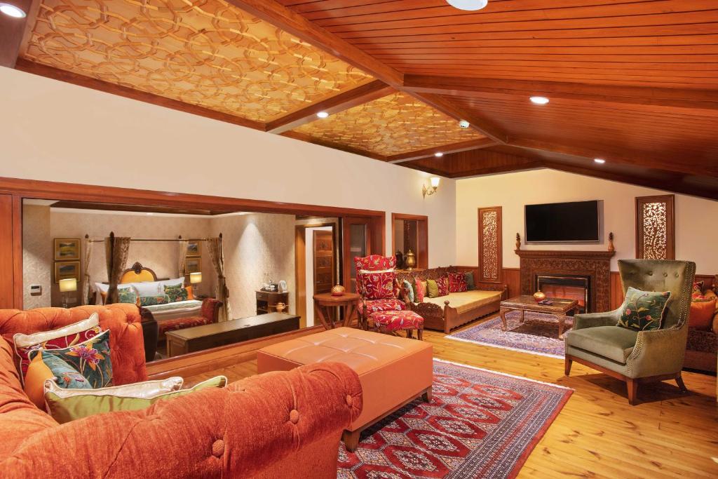 a large living room with couches and a tv at Welcomhotel by ITC Hotels, Pine N Peak, Pahalgam in Pahalgām