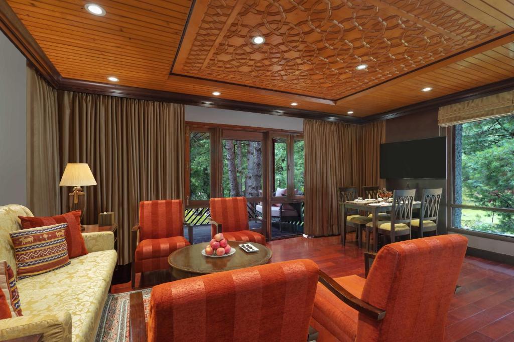 a living room with a couch and a table at Welcomhotel by ITC Hotels, Pine N Peak, Pahalgam in Pahalgām