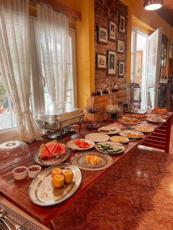 a buffet with many plates of food on a table at Guesthouse Lord Byron in Tepelenë