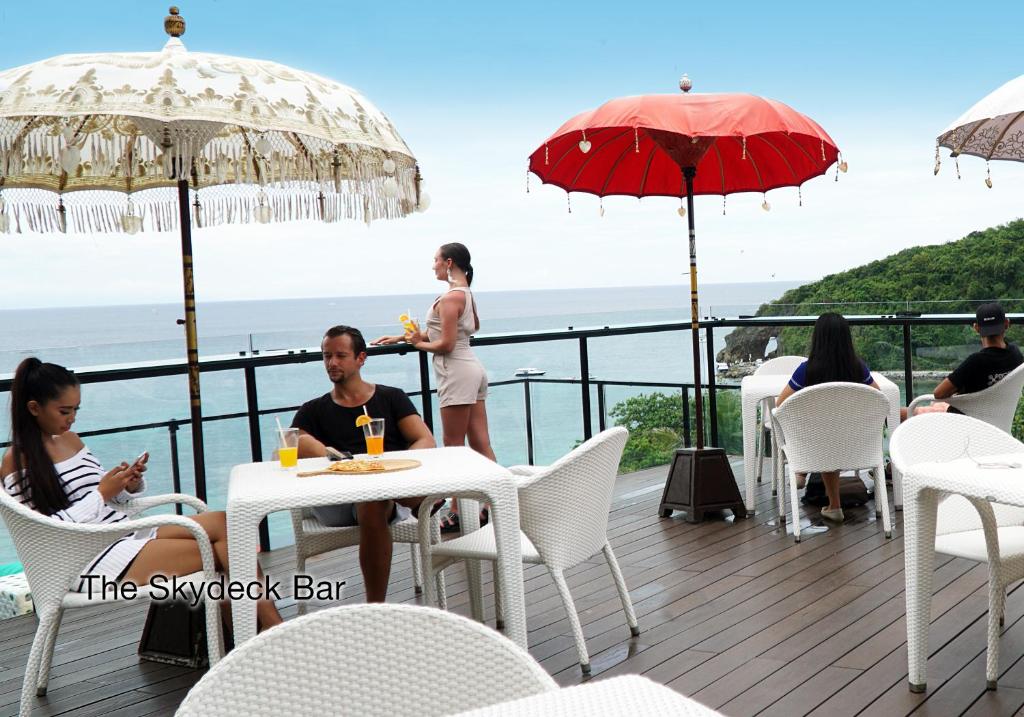 a group of people sitting at tables on a deck at Fairways and Bluewater Boracay in Boracay