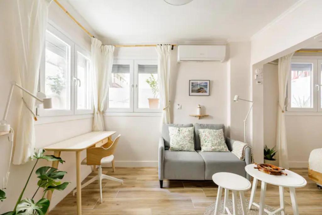 a living room with a couch and a table at Lovely small (parterre) apartment in Thessaloniki in Thessaloniki