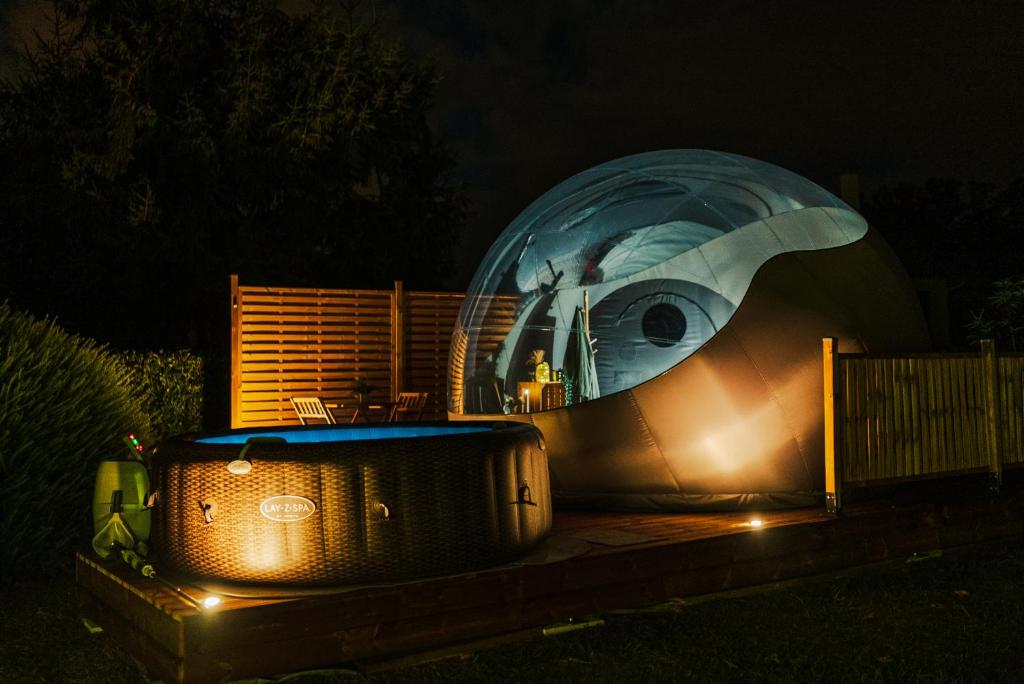 a domed observatory at night with lights on it at Reves2bulles in Ousse