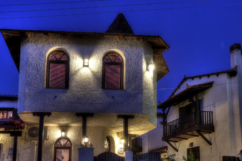 a building with lights on the side of it at night at Chateaux Constantin Agistro in Angistron