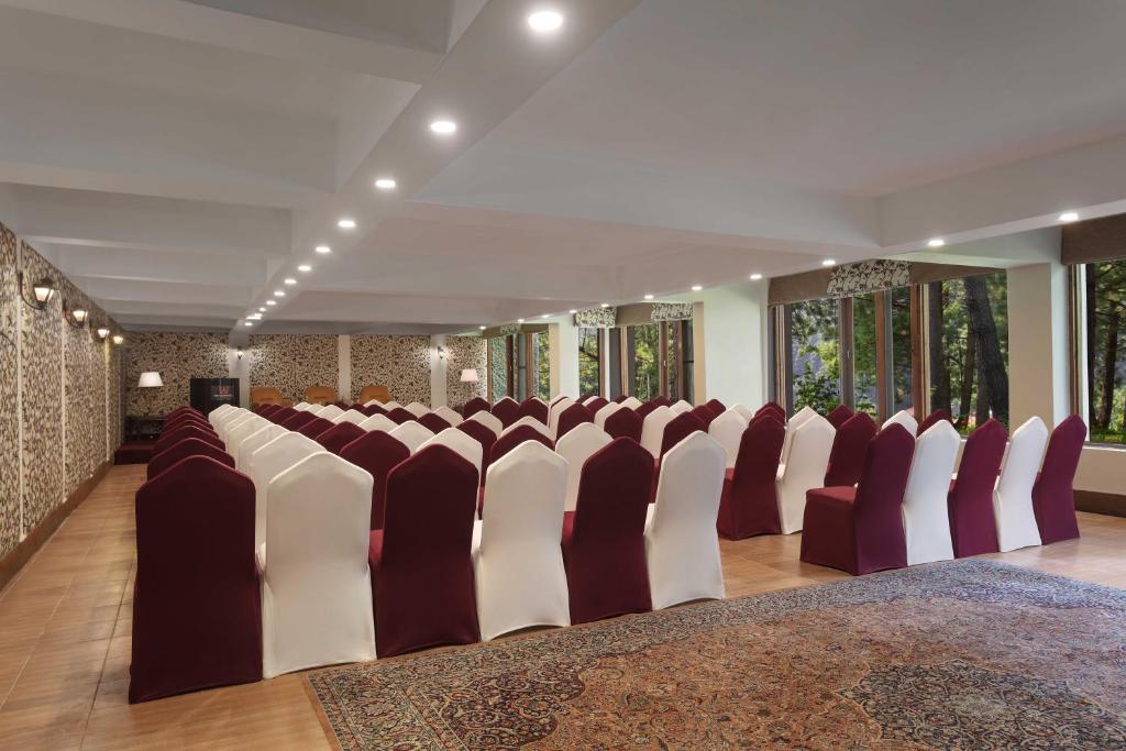 a row of chairs in a large room with windows at Welcomhotel by ITC Hotels, Pine N Peak, Pahalgam in Pahalgām