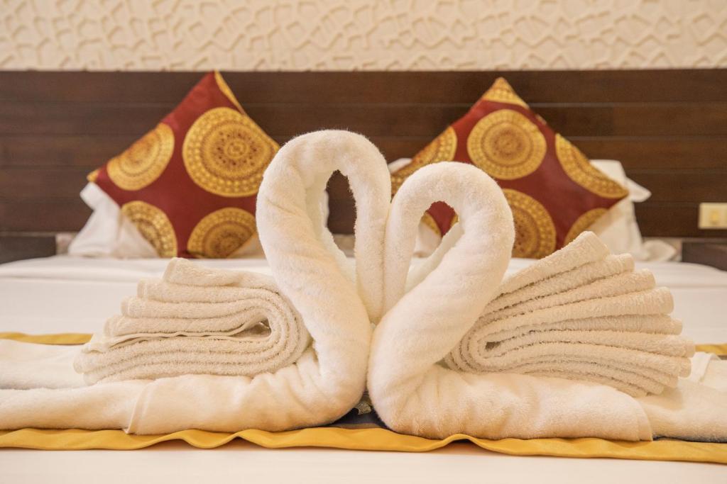 Postel nebo postele na pokoji v ubytování Lily Holiday hotel 百合假日酒店
